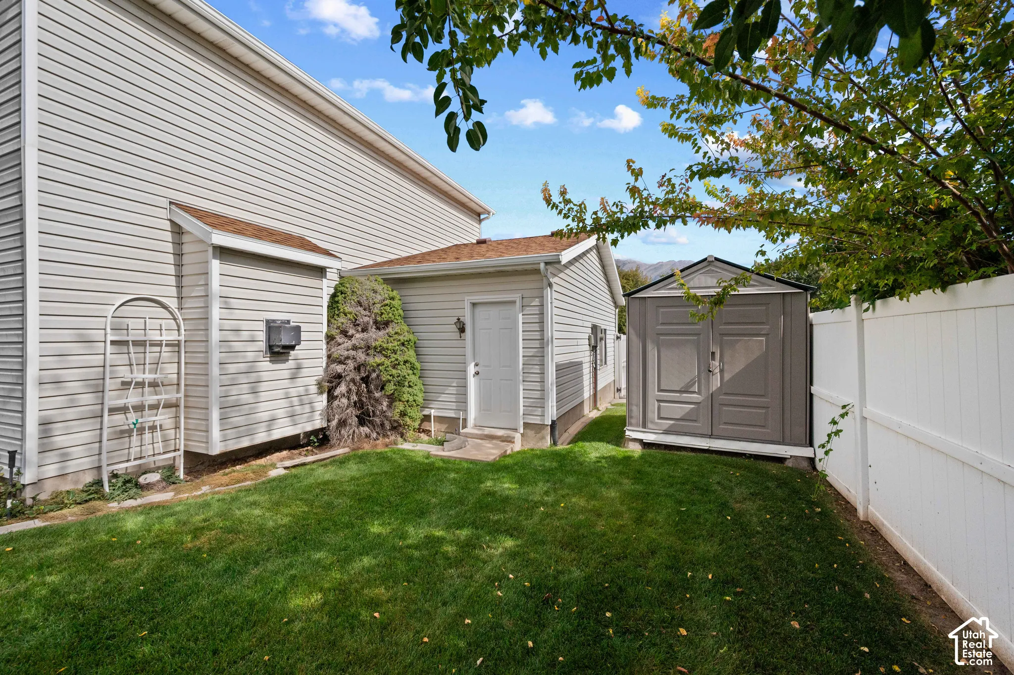 Exterior side yard featuring an exterior storage structure