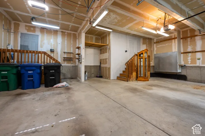 3-car garage with built-in wood staircases