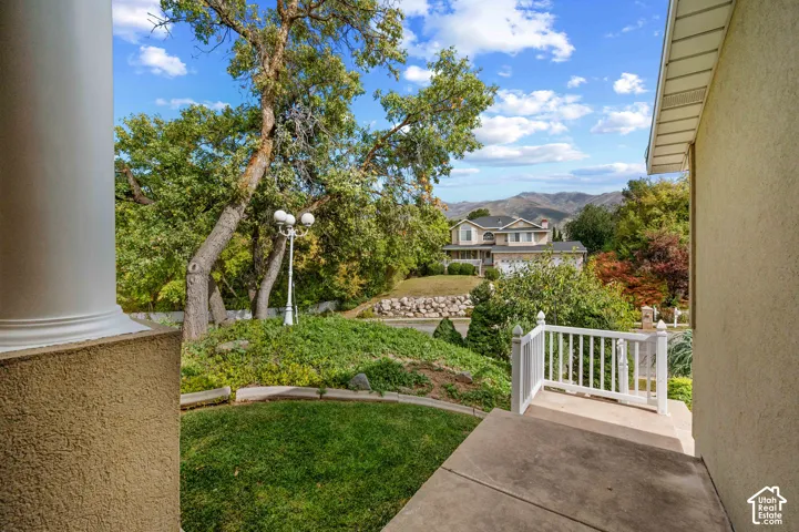 View from the front door complemented by mature landscaping, and mountain topography