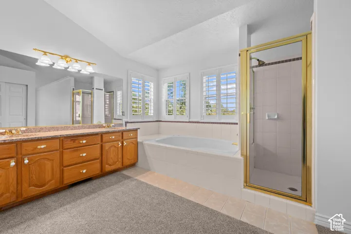 Primary bathroom featuring a double vanity and an oversized wall mirror