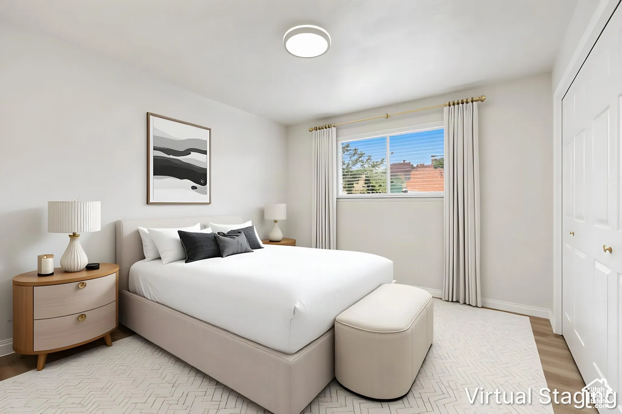 Neutral-toned interior room featuring wood-finish flooring, a large sliding window, a circular flush-mount ceiling light fixture, and double-door reach-in closet cabinetry