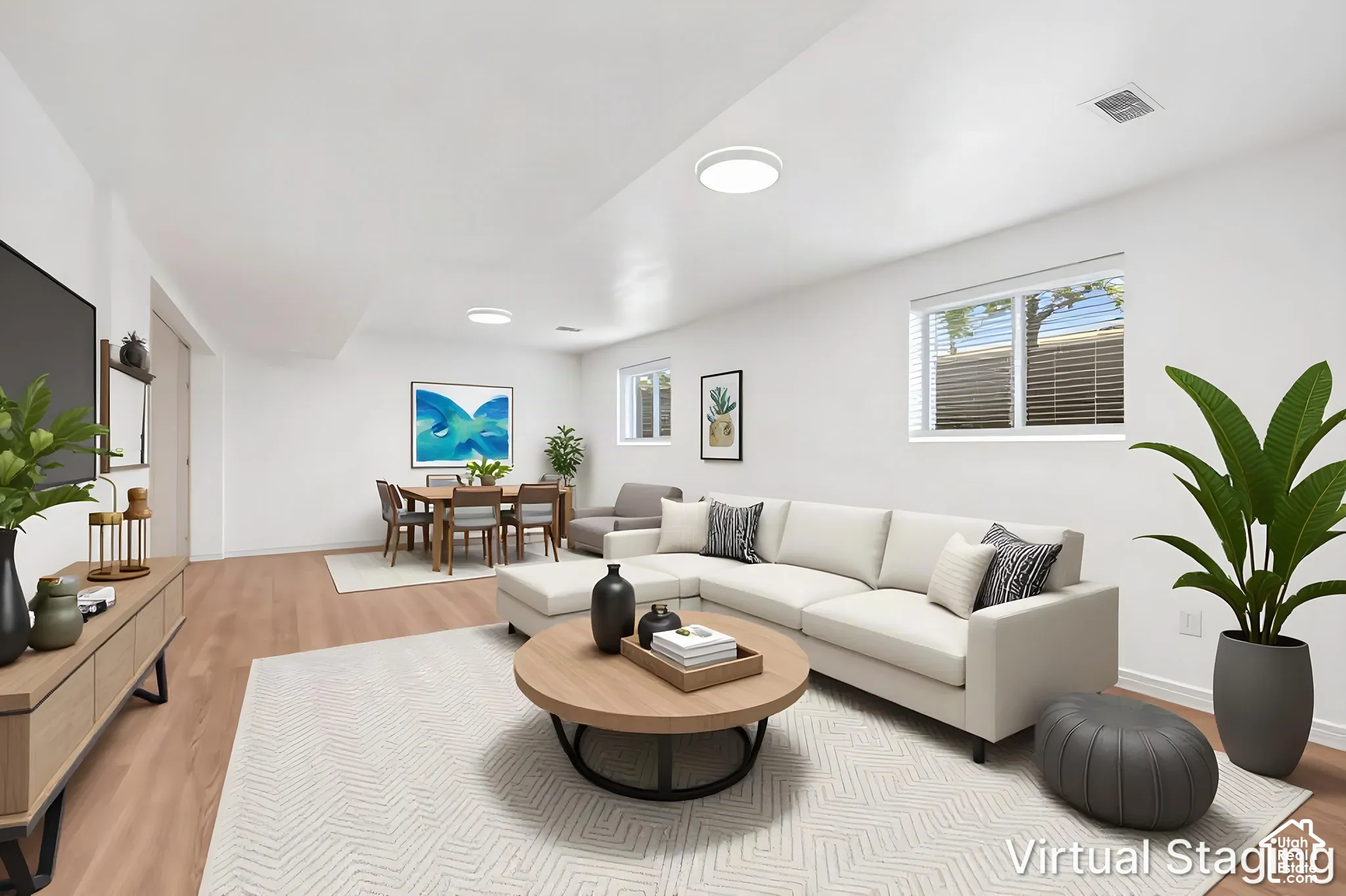 Open-concept interior featuring wood-finish flooring, recessed lighting, and multiple horizontal slider windows