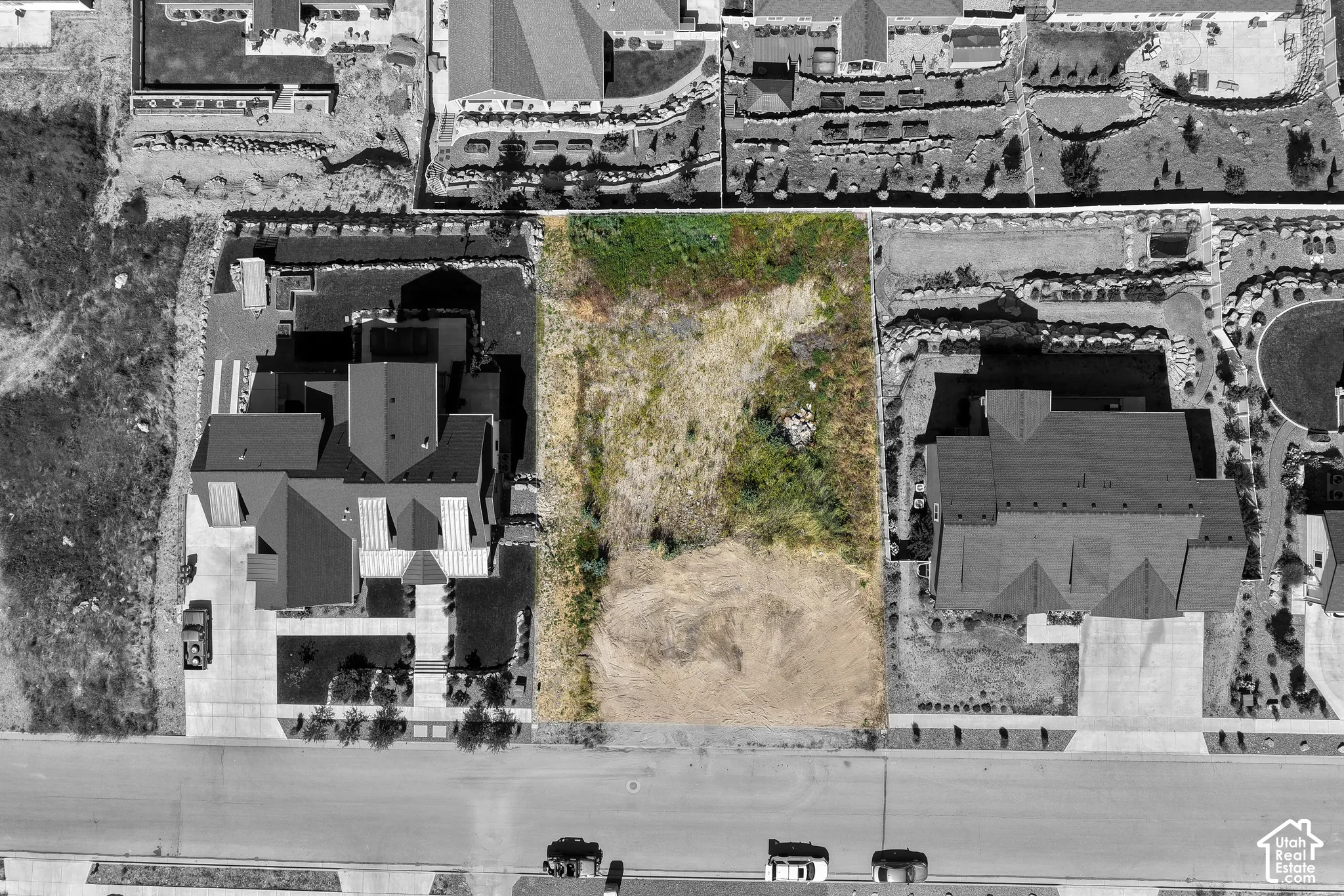 Rectangular residential lot positioned between two developed properties with street frontage