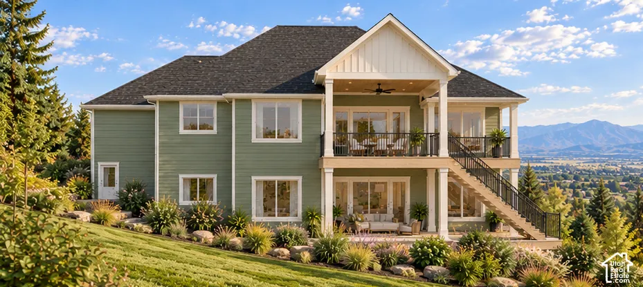 Two-story exterior featuring sage-colored lap siding, a shingled roof, a covered second-story balcony with metal railings, a ground-level patio, and a staircase