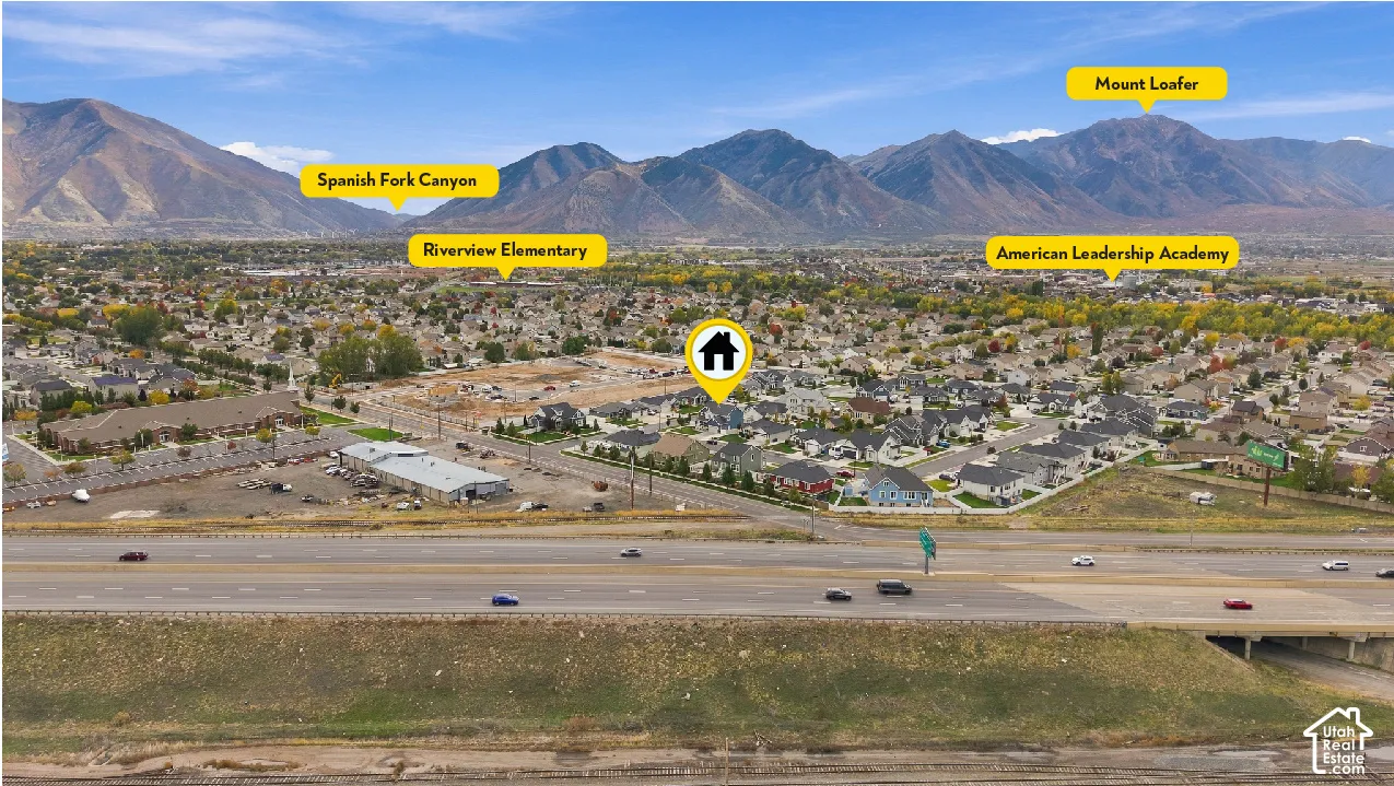 Aerial perspective featuring a residential lot in a suburban setting, highlighted by a backdrop of mountain ranges