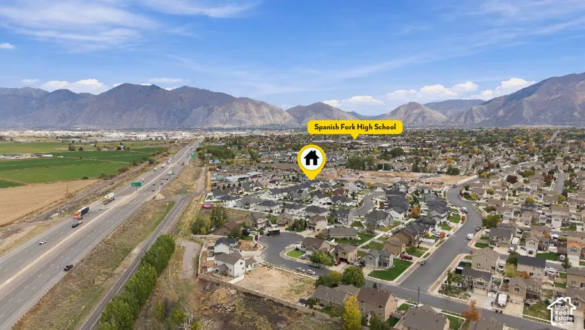 Aerial view of suburban residential neighborhood featuring mountain topography and proximity to regional transit infrastructure