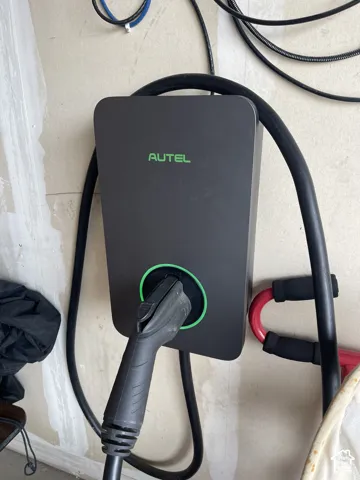 Wall-mounted Autel electric vehicle charging station with integrated cable storage