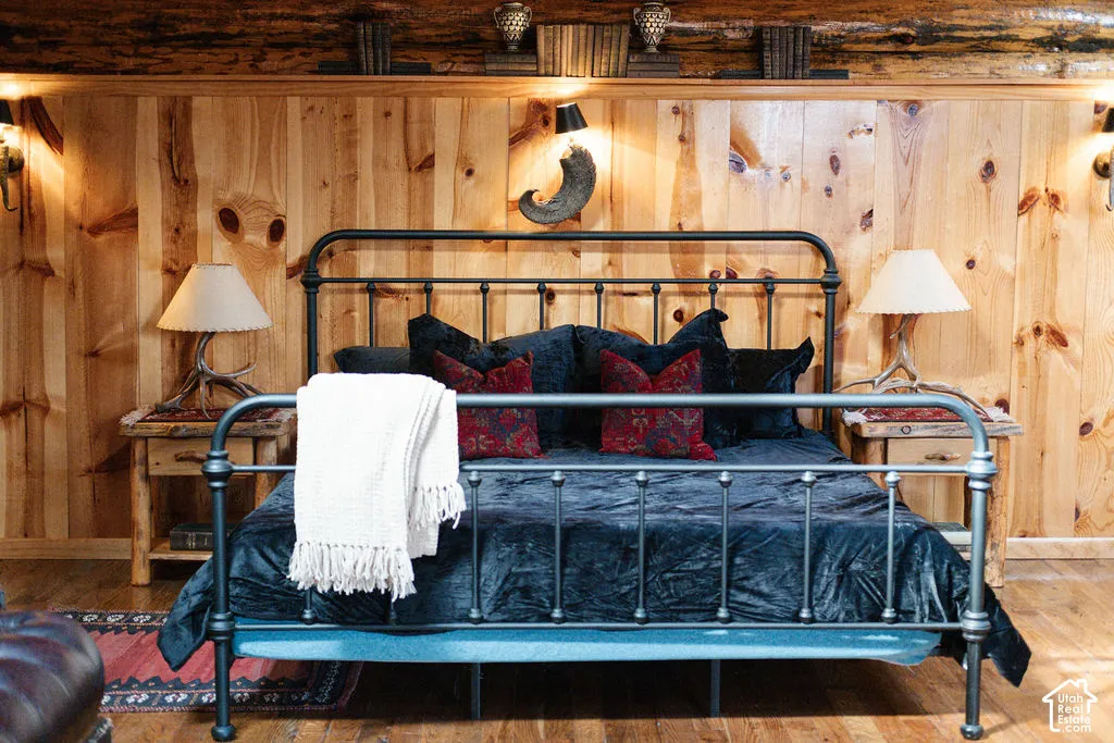 Knotty wood paneling, exposed log timber header, and wood-finish flooring