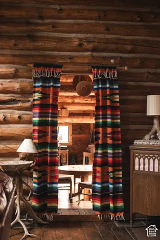 Log walls featuring authentic wood grain textures and plank flooring