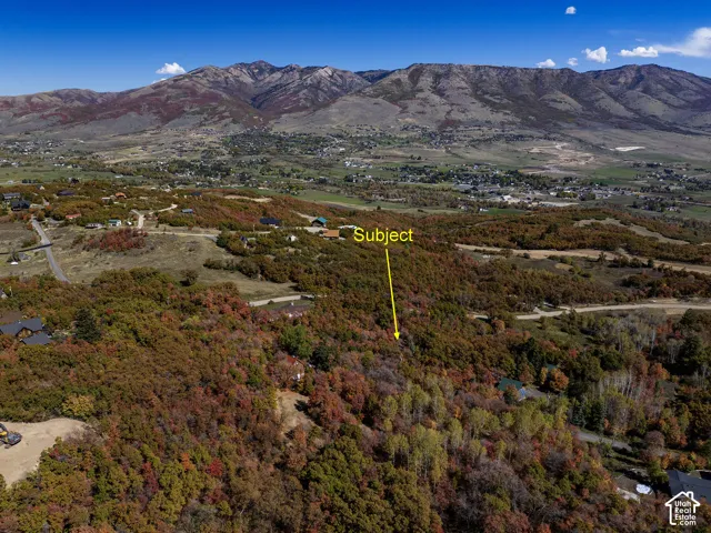 Elevated parcel featuring mature deciduous trees and panoramic mountain topography