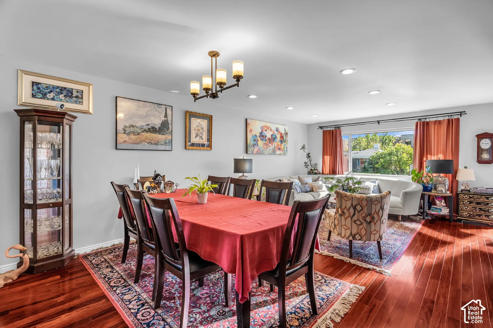 Living area featuring wood-finish flooring, recessed lighting, and a multi-light chandelier