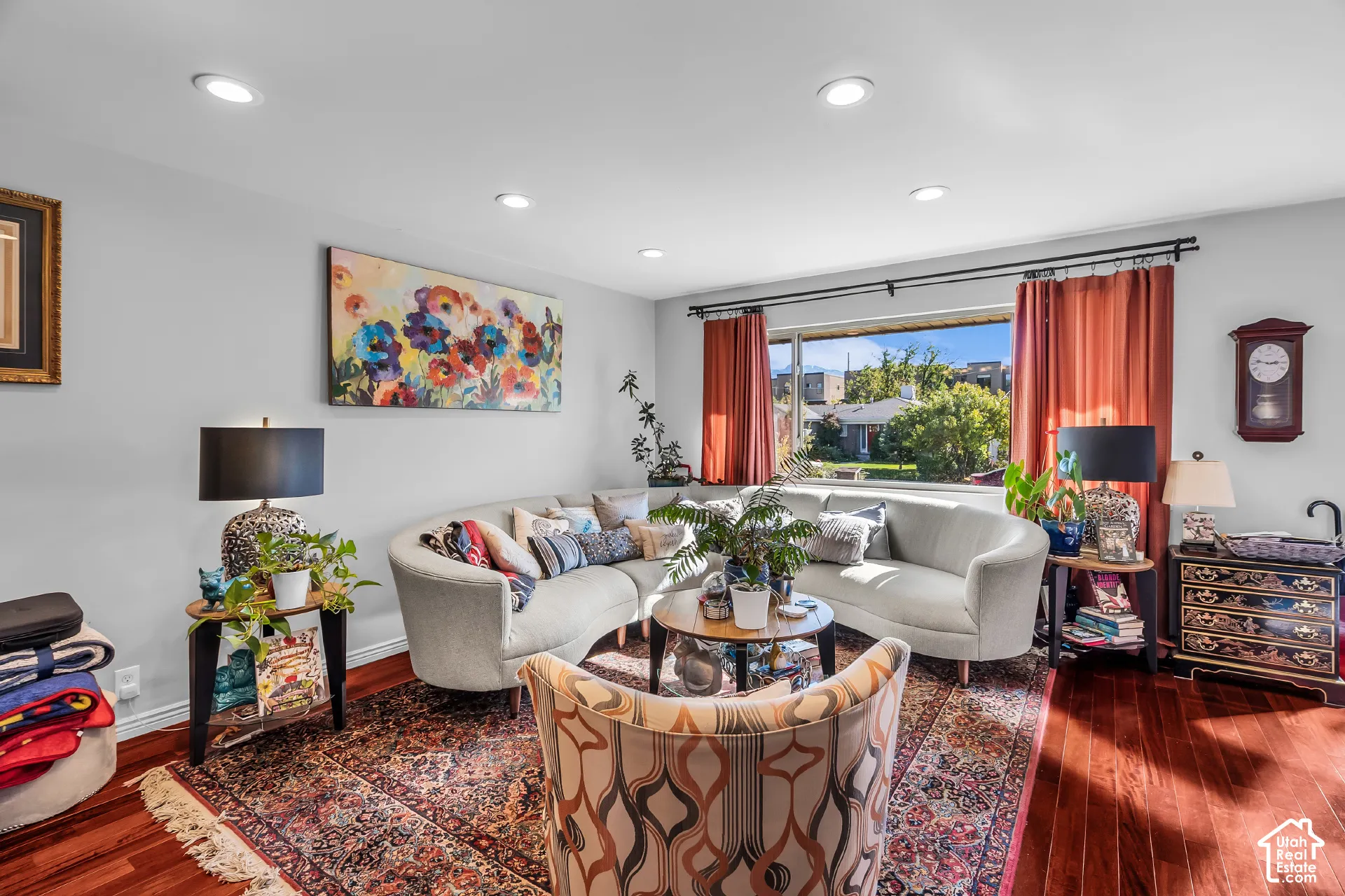 Living area featuring wood-finish flooring, recessed lighting, and a large picture window