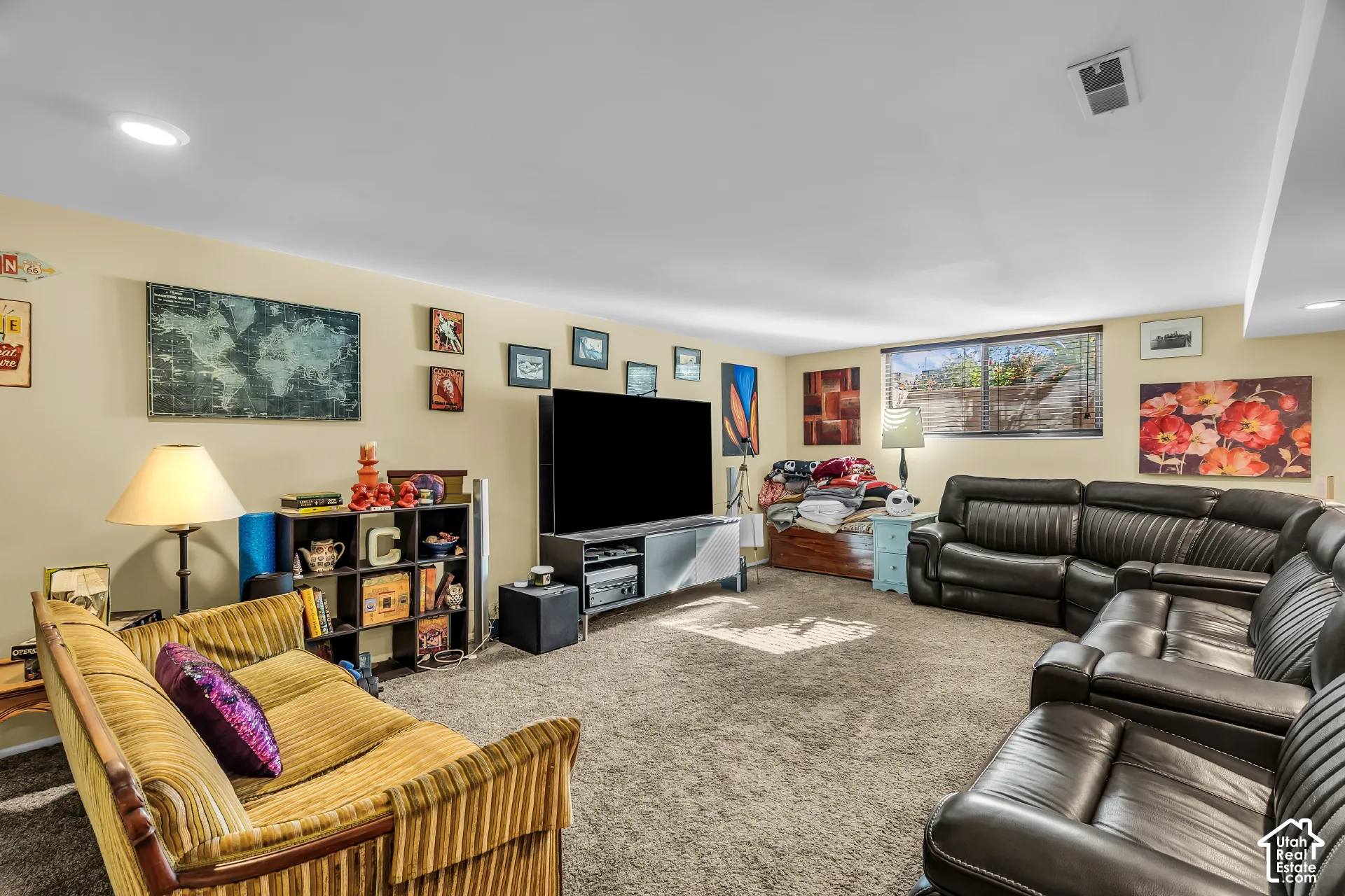 Spacious interior room featuring neutral wall tones, recessed lighting, and wall-to-wall carpeting