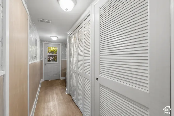Hallway featuring laundry room