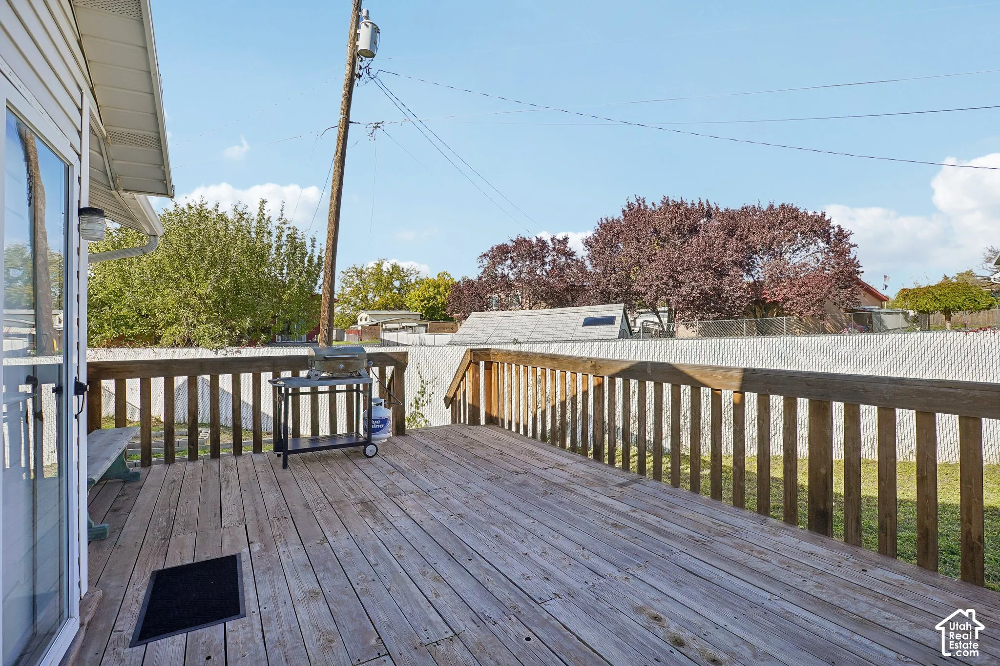 Elevated wood deck featuring a wooden railing and a fenced backyard