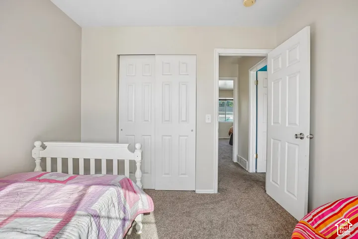 Neutral-toned walls, wall-to-wall carpeting, and sliding panel closet doors