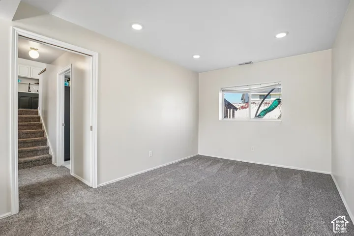 Interior room featuring neutral wall paint, recessed lighting, and wall-to-wall carpeting