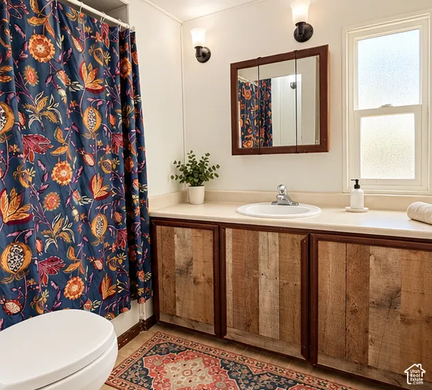 Bathroom featuring custom wood-plank cabinetry, integrated solid-surface countertop with an undermount sink, tri-fold medicine cabinet, and dual wall-mounted light fixtures