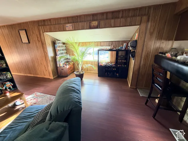 Wood-paneled walls, built-in recessed alcove, and wood-finish flooring