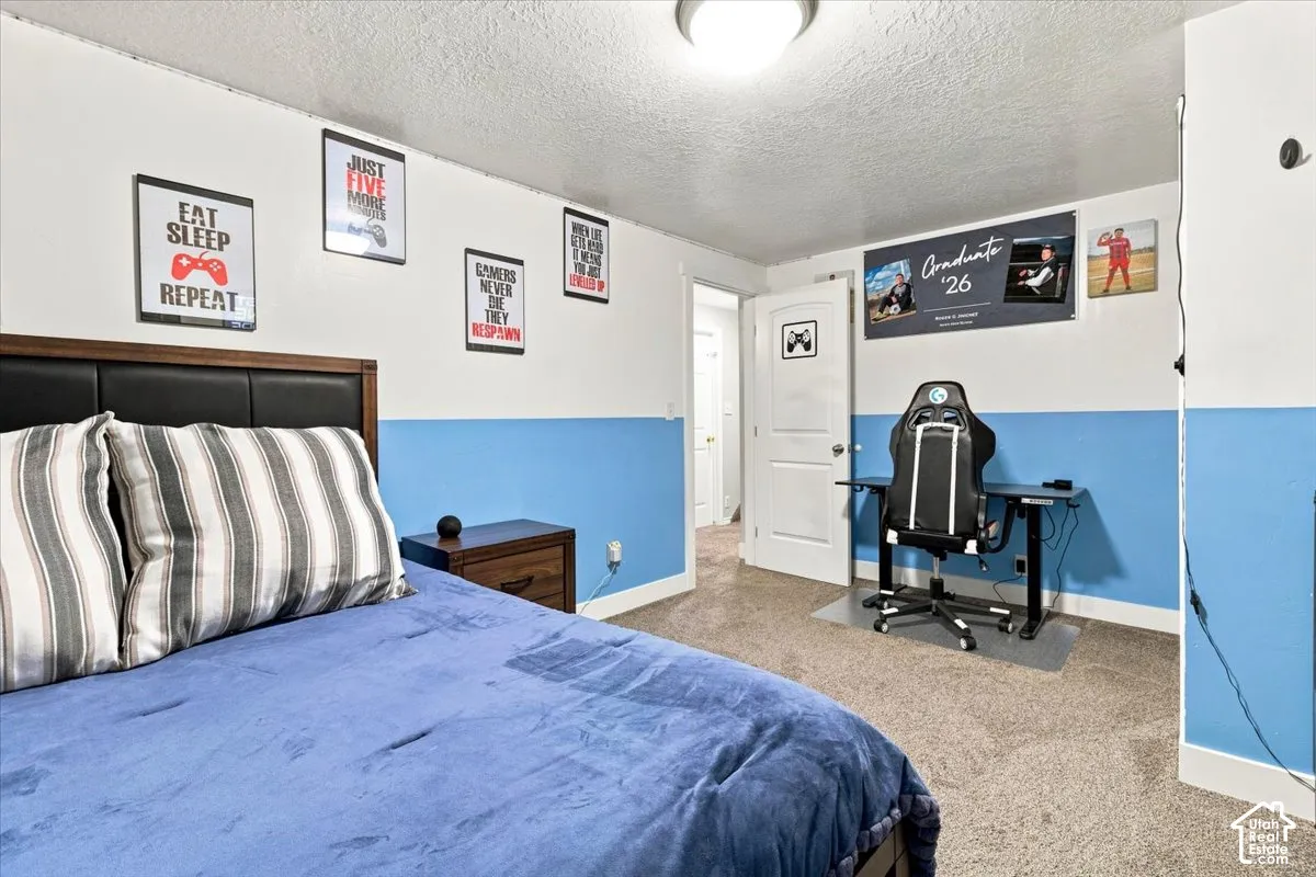 Bedroom featuring wall-to-wall carpeting, two-tone wall paint, and a white six-panel interior door