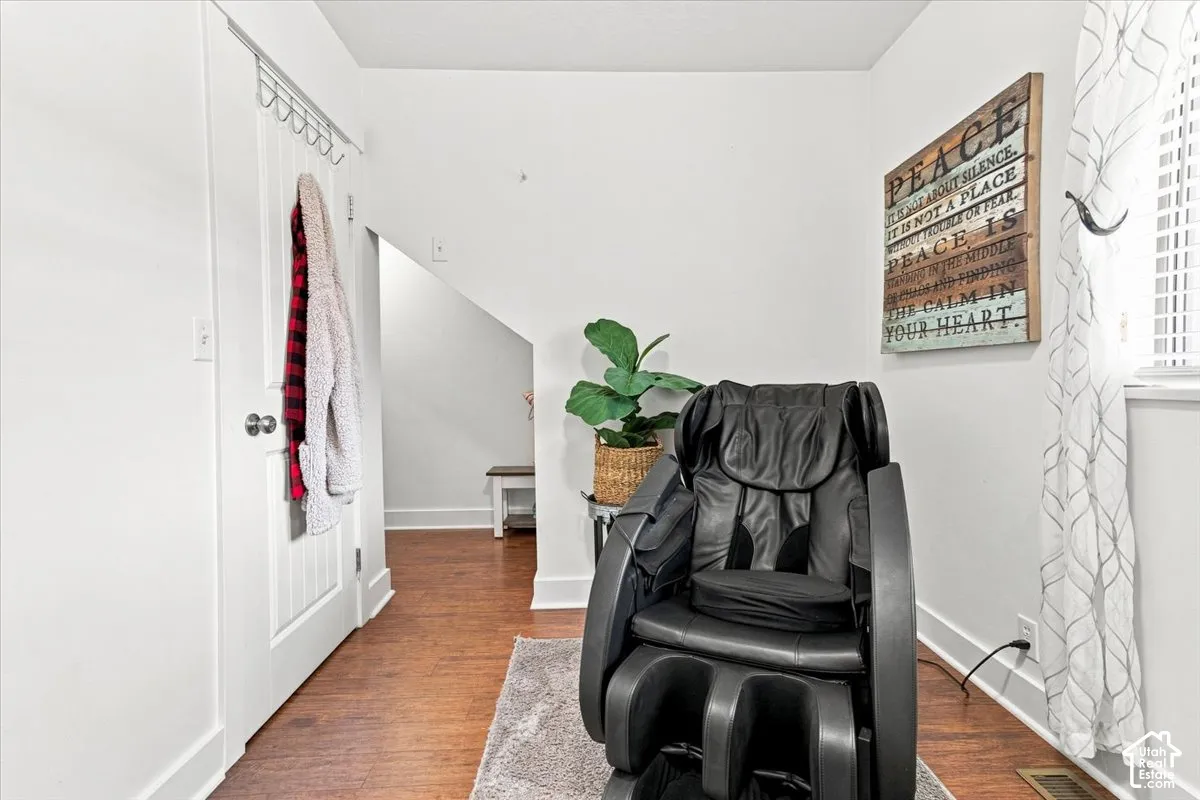 Interior space featuring wood-finish flooring and a white paneled door