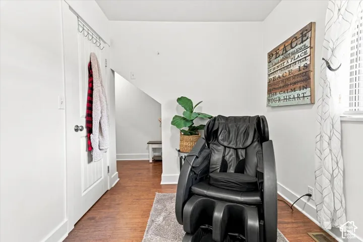 Interior space featuring wood-finish flooring and a white paneled door