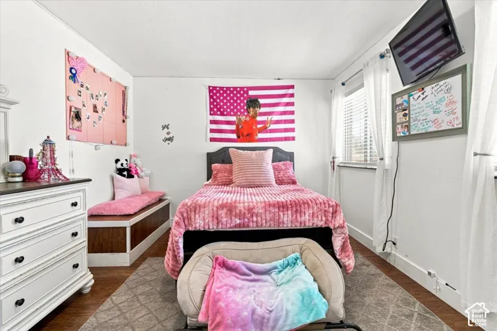 Wood-finish flooring, built-in window bench with storage, and horizontal slat window blinds