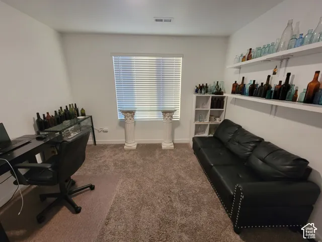 Neutral wall palette, wall-to-wall carpeting, window with blinds, and dual white floating shelves