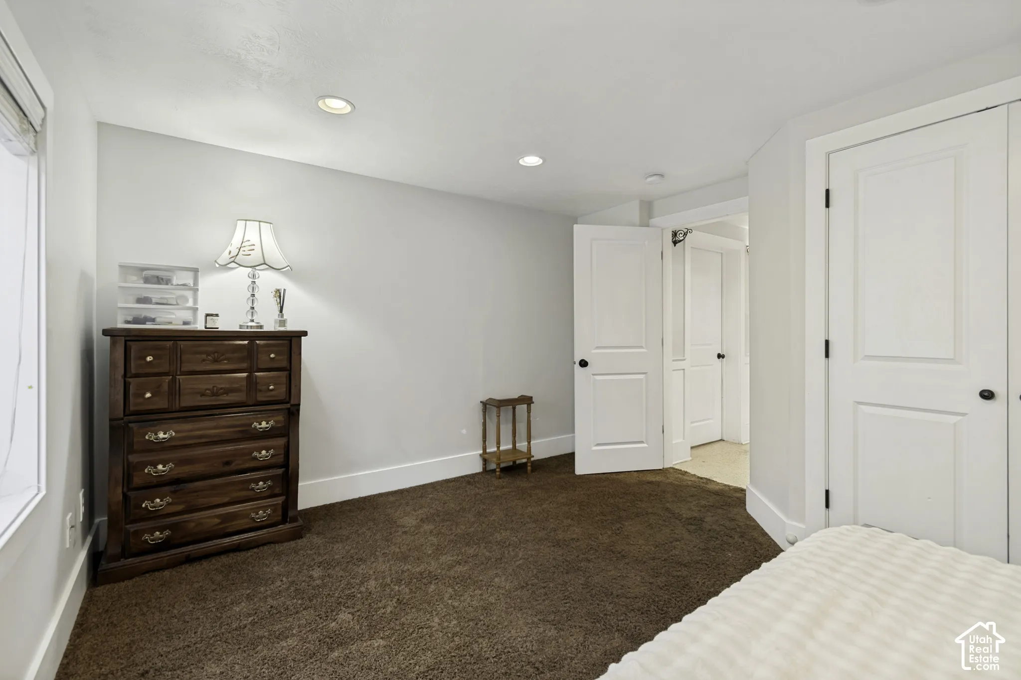 Room featuring carpeted flooring, recessed lighting, and double-panel doors