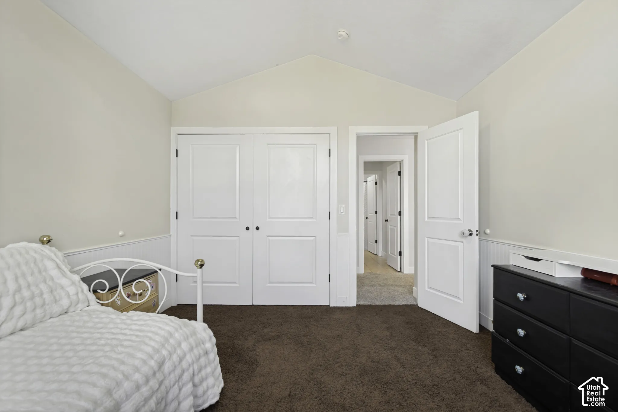 Vaulted ceilings, paneled wainscoting, and double-door reach-in closet