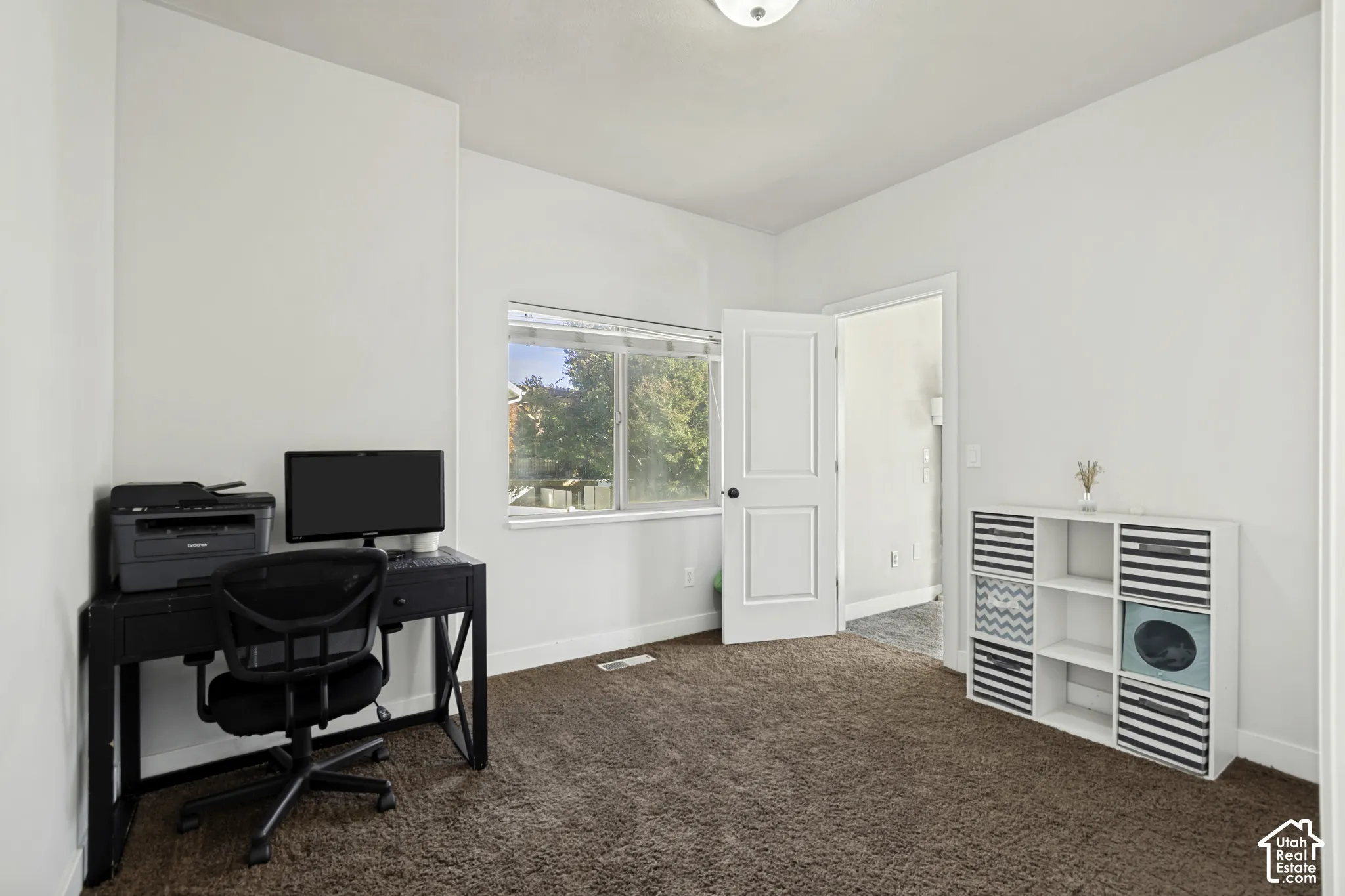 Neutral wall coloring, wall-to-wall carpeting, single-hung window, and two-panel interior door