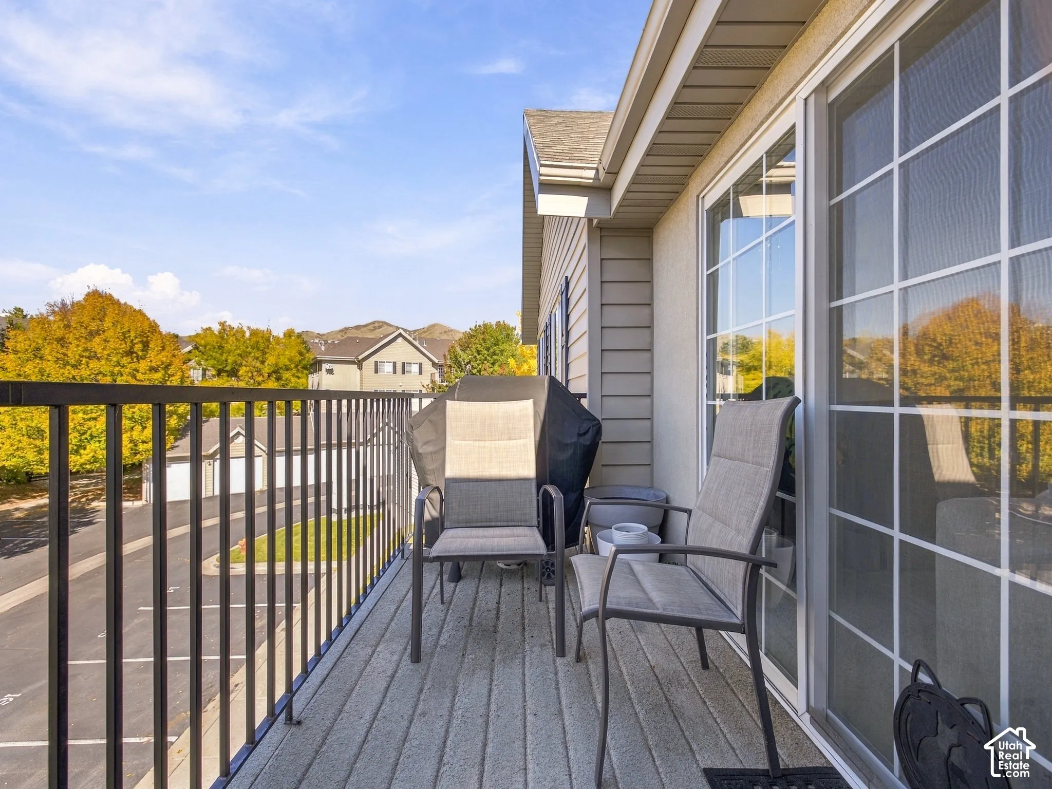 Private balcony featuring metal railings, horizontal siding, and grid-pattern glass sliding doors