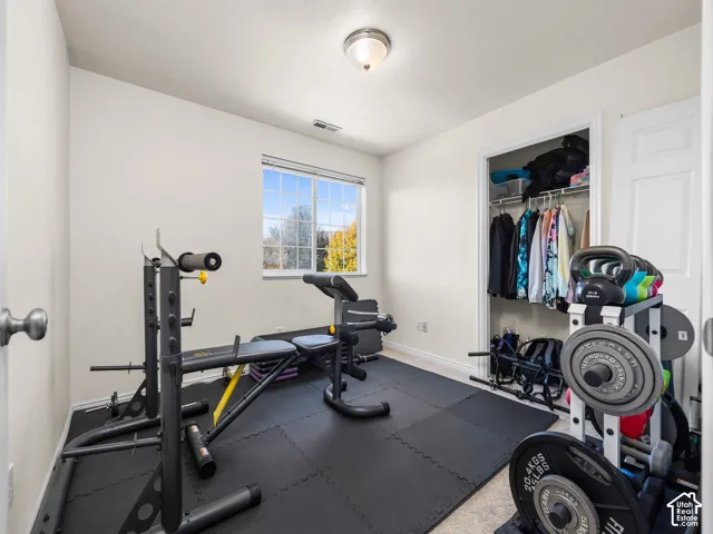 Neutral interior room featuring a single-panel window, flush-mount ceiling lighting, and a closet with integrated shelving