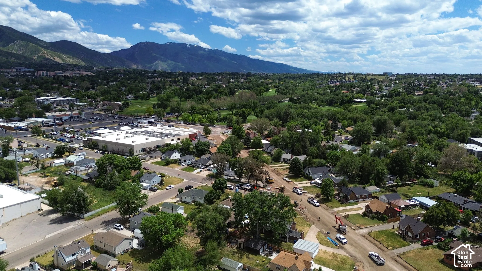 Aerial perspective featuring established residential surroundings and mountain range backdrop