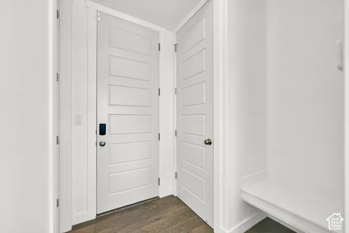 White five-panel interior doors, wood-finish flooring, and built-in bench seating