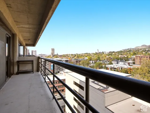 Covered balcony featuring concrete flooring and a metal railing