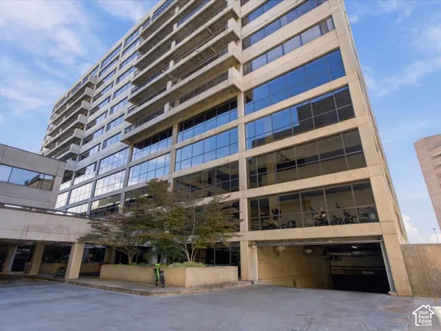 Mid-rise concrete exterior featuring expansive glass curtain walls and private cantilevered balconies