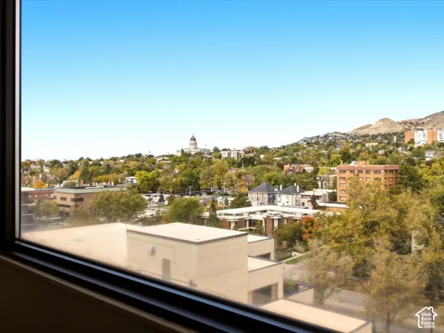 Floor-to-ceiling windows featuring panoramic city and mountain scenery