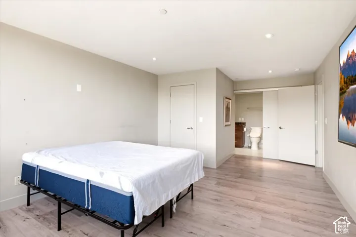 Wood-finish flooring, recessed lighting, and neutral wall tones