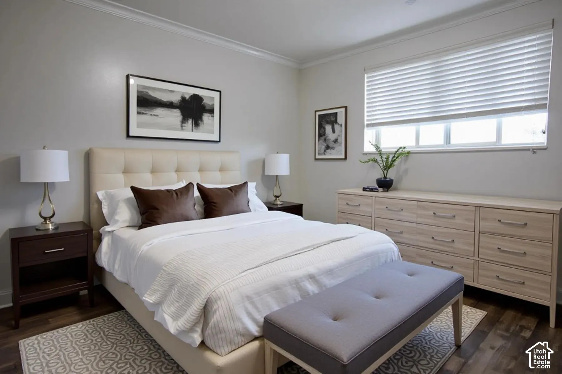 Neutral-toned wall paint, wood-finish flooring, and horizontal window blinds