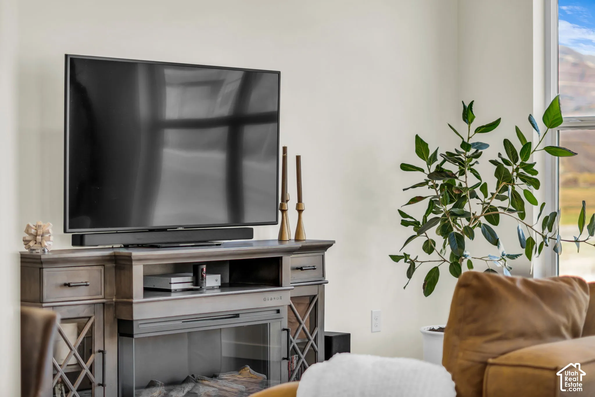 Neutral-toned interior wall with a prominent window revealing a mountainous backdrop