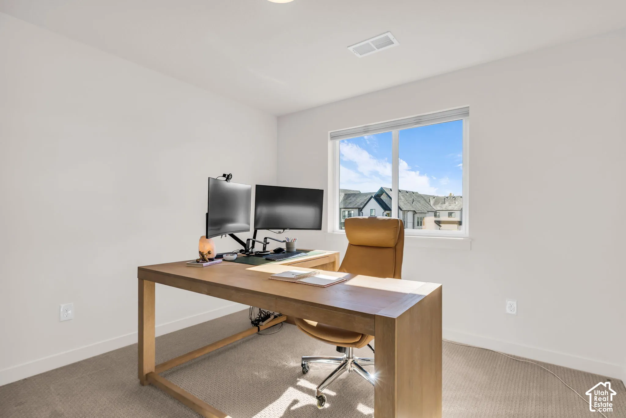 Neutral-toned wall paint, high-performance carpeting, and a dual-pane window featuring integrated horizontal blinds