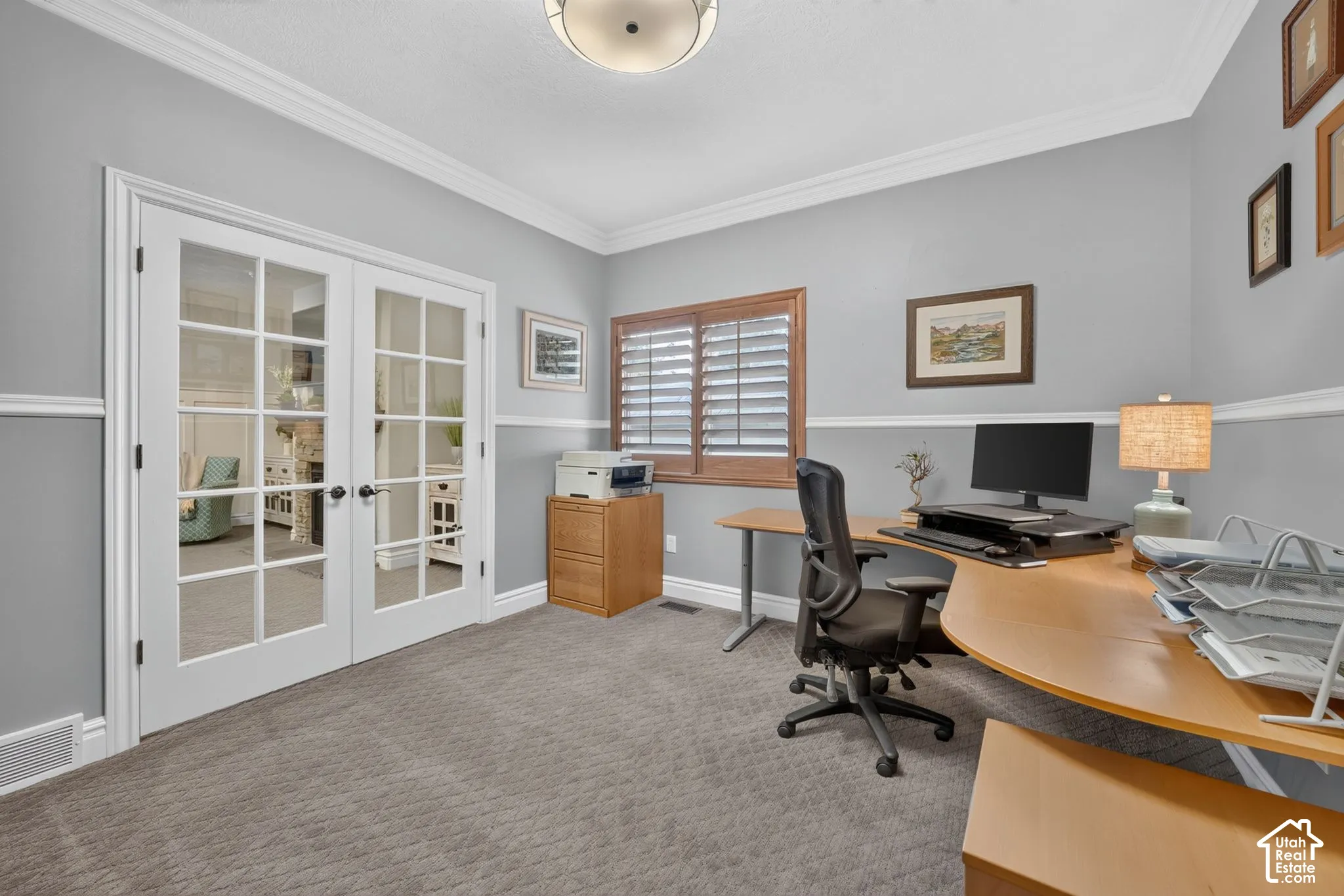 French doors with glass panes, crown molding, chair rail trim, and window shutters