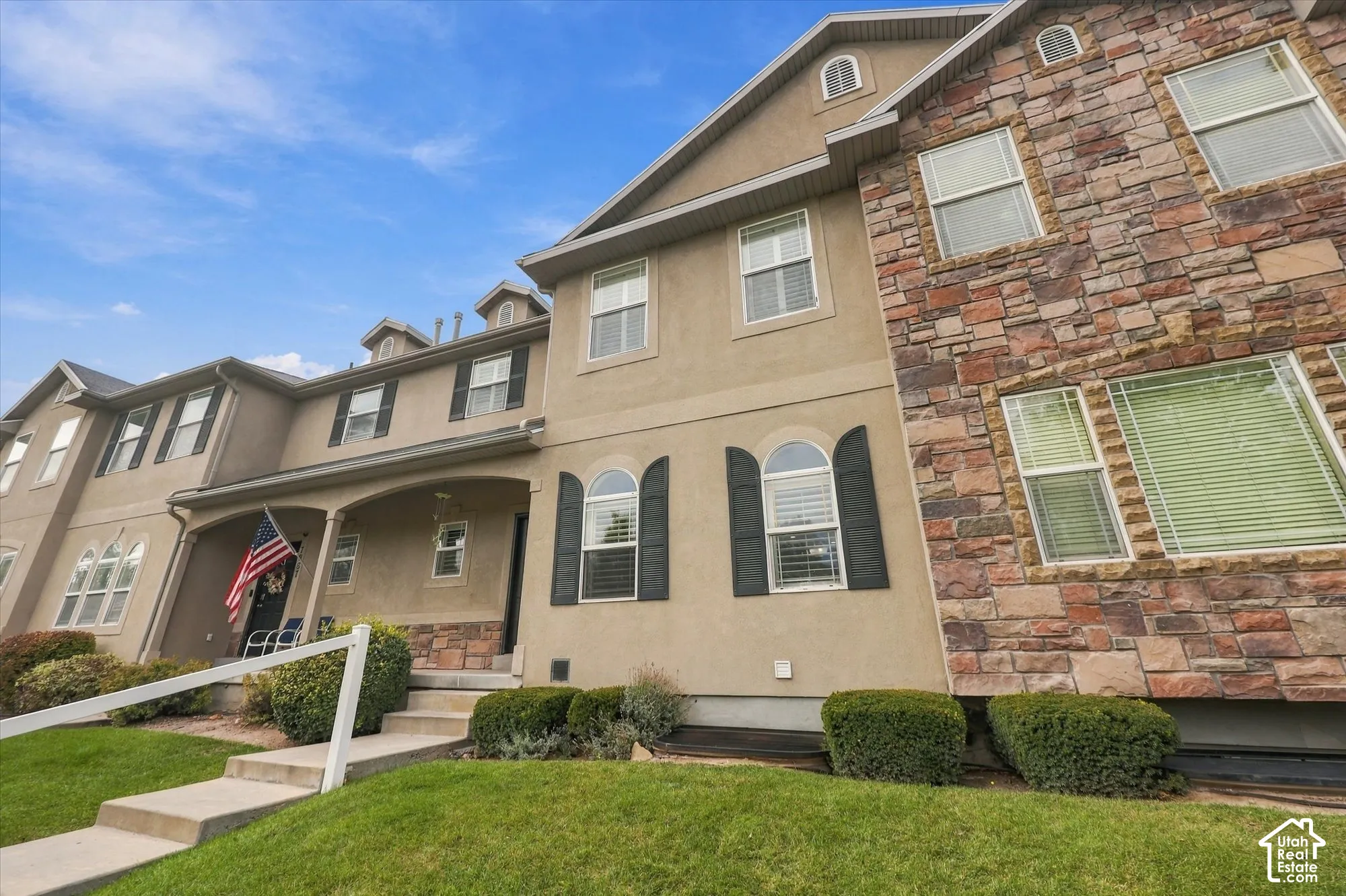 Multi-story exterior featuring a stone and stucco fa