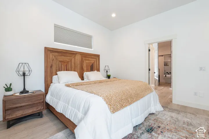 Room featuring wood-finish flooring, a horizontal transom window, and recessed ceiling lighting