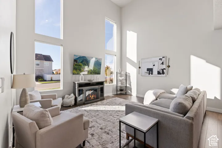 Double-height ceilings featuring floor-to-ceiling windows and wood-finish flooring