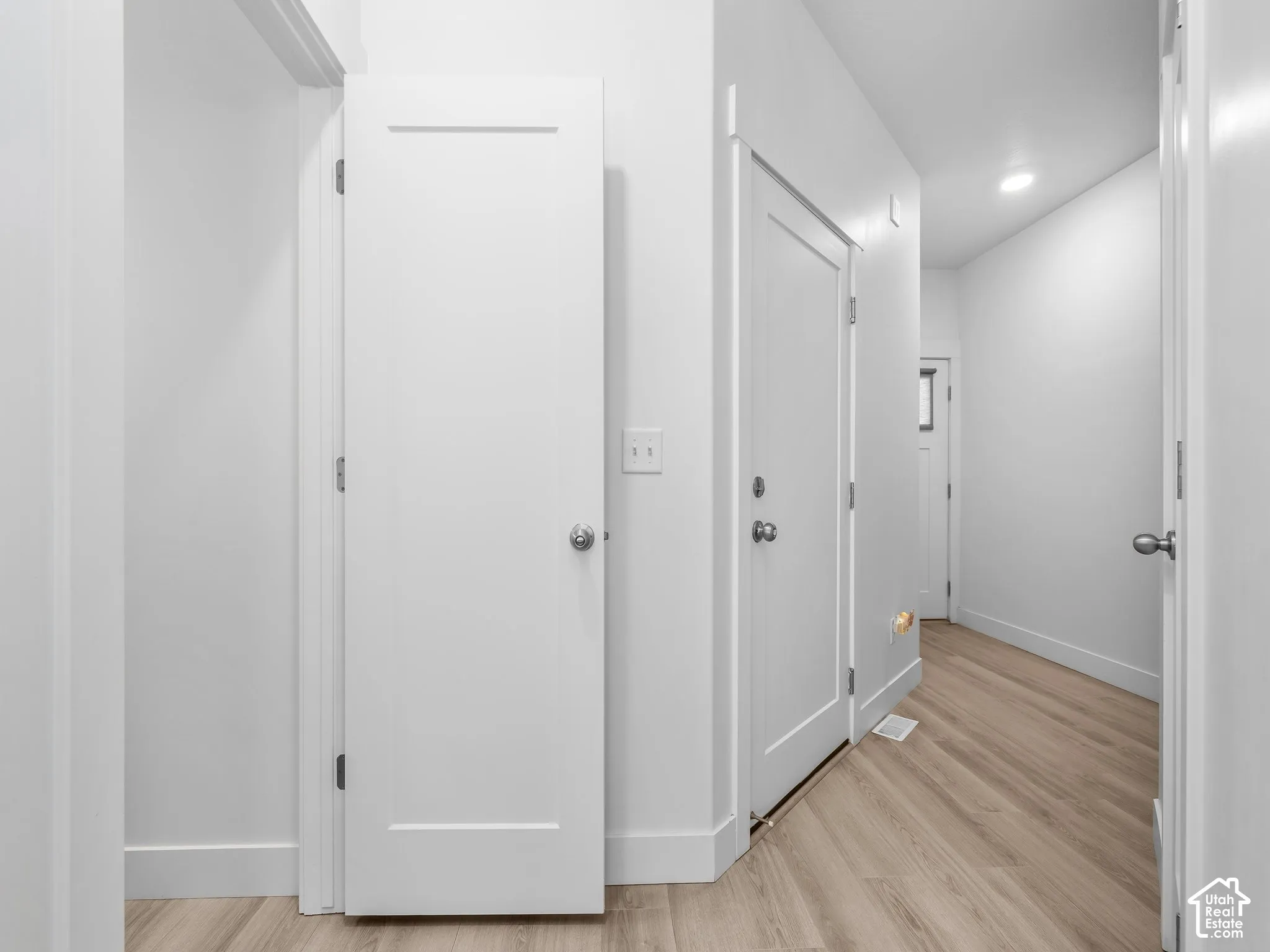 Wood-finish flooring, shaker-style interior doors, and recessed lighting