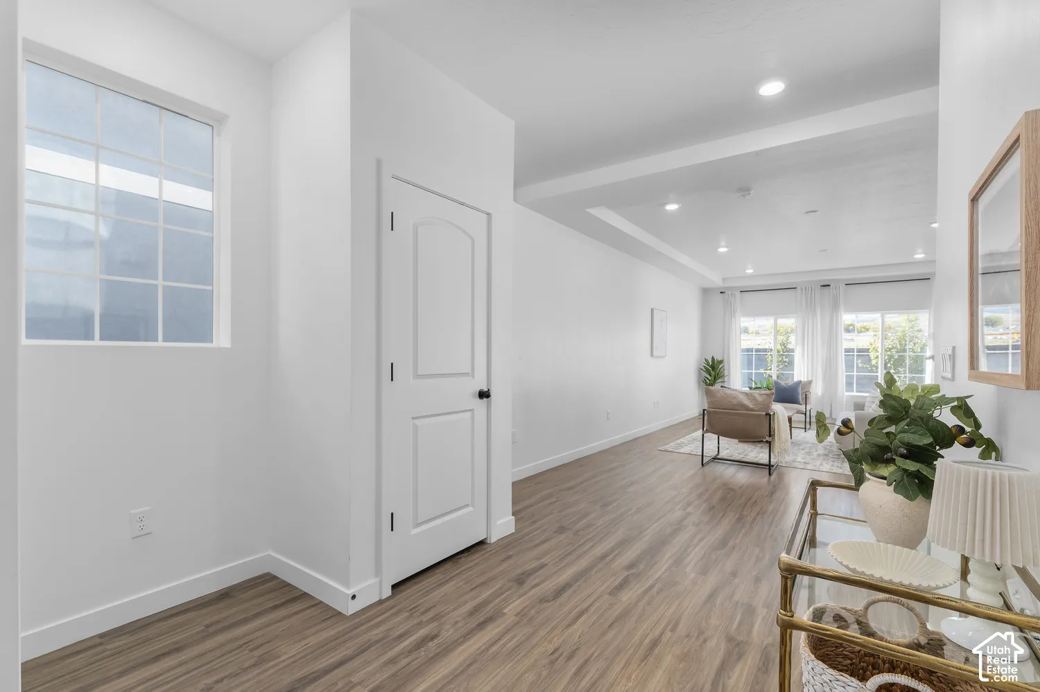 Wood-finish flooring, recessed lighting, coffered ceiling, and multi-pane window