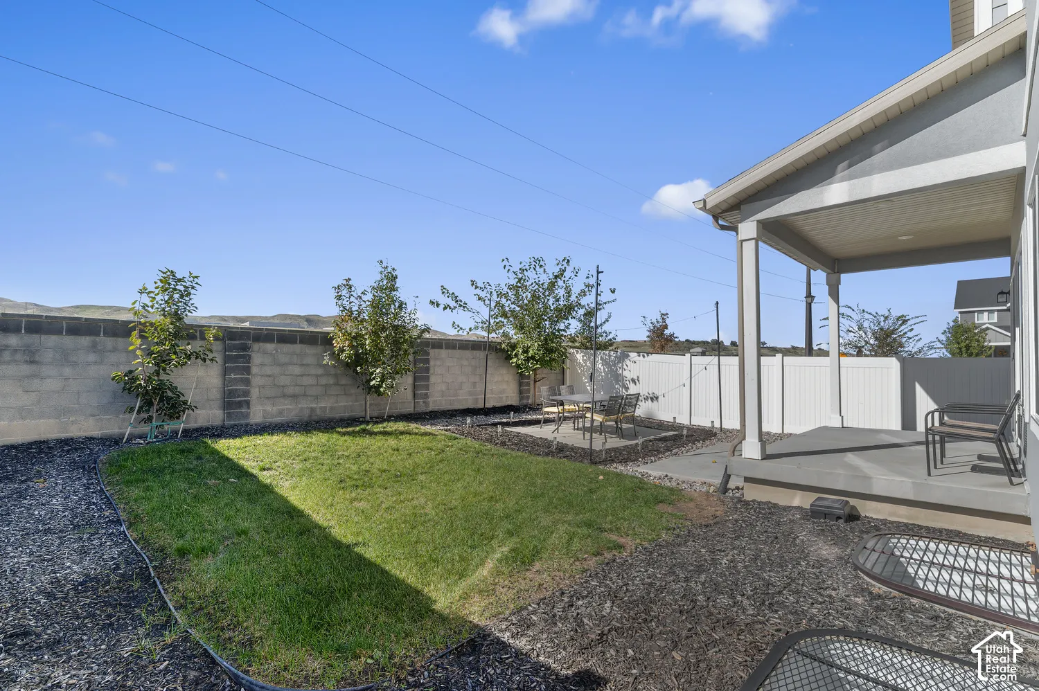 Backyard featuring a covered patio, concrete hardscaping, a lawn area, and a privacy fence