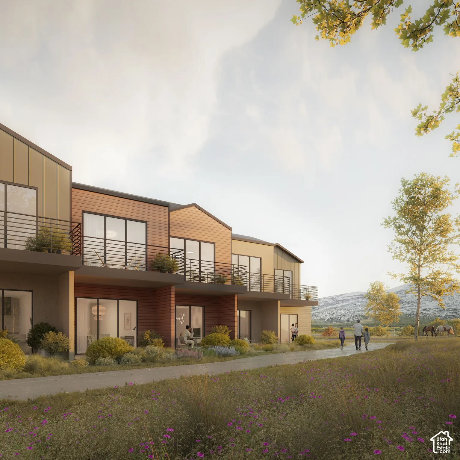 Multi-unit exterior featuring mixed-material siding, expansive sliding glass doors, private upper-level balconies with metal railings, and concrete pathways